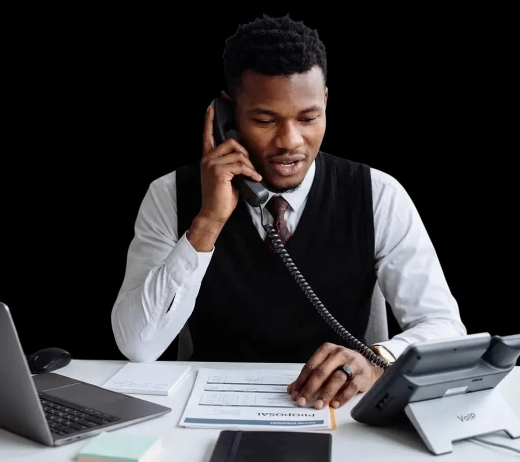 A sales rep on a call, wearing the TellHalo ring while reviewing a proposal